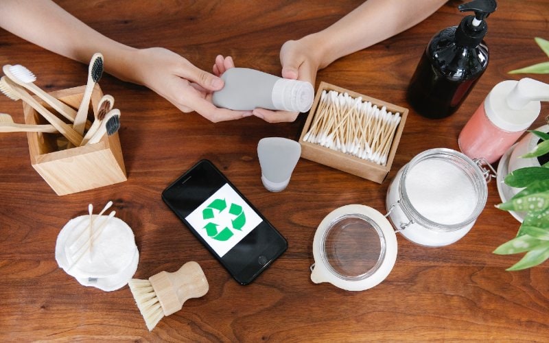 person inspecting a collection of recycled products