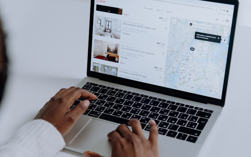 person using laptop for property rental listing