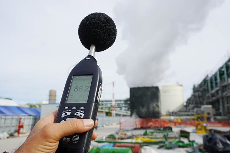 person using sound level meter outdoor