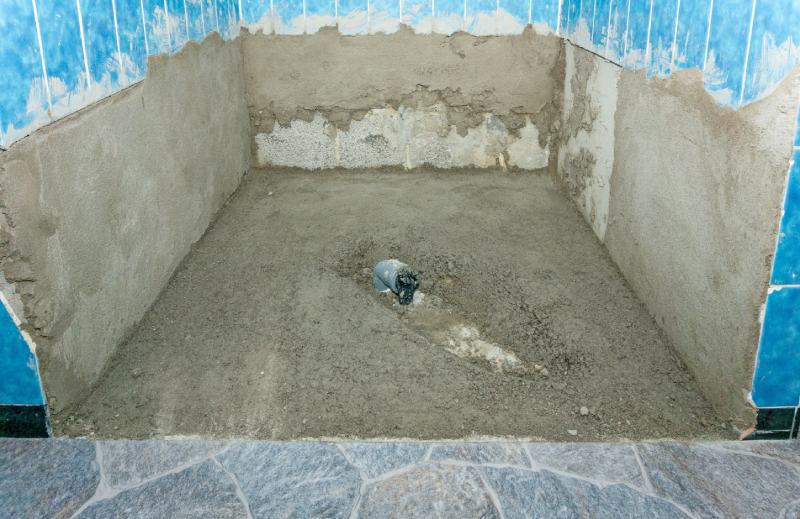 shower cabin with new concrete flooring during a bathroom renovation modernization project