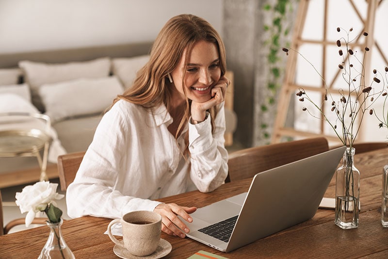 smiling woman using laptop
