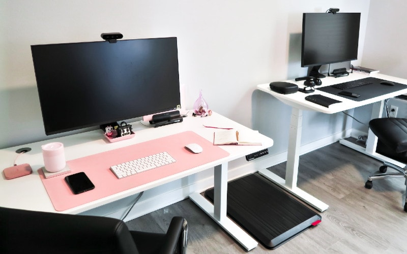two computer stations on adjustable standing desks
