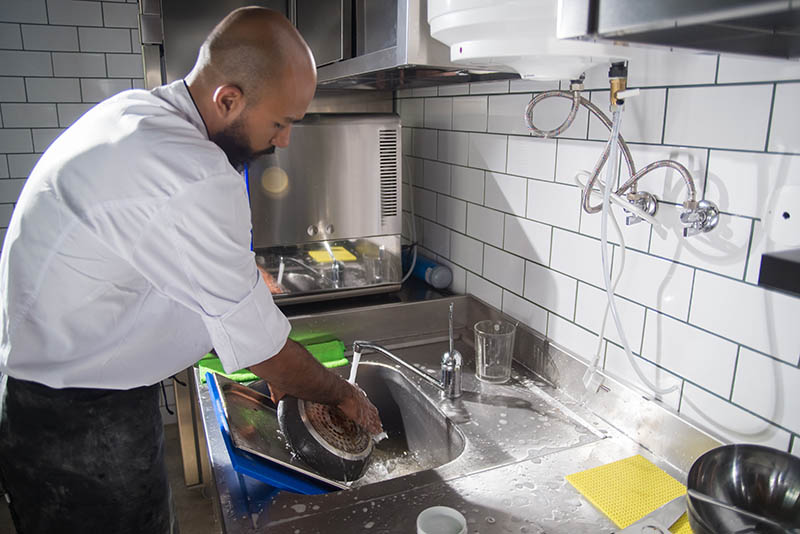 washing frying pan on the sink