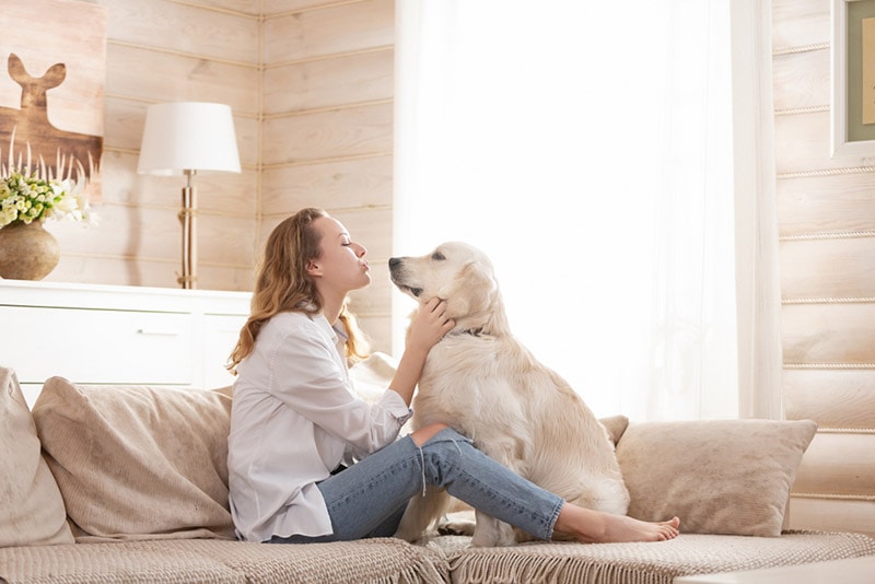 woman cuddling with her dog