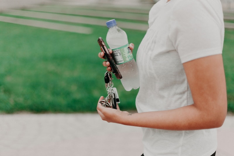 woman holding bottled water