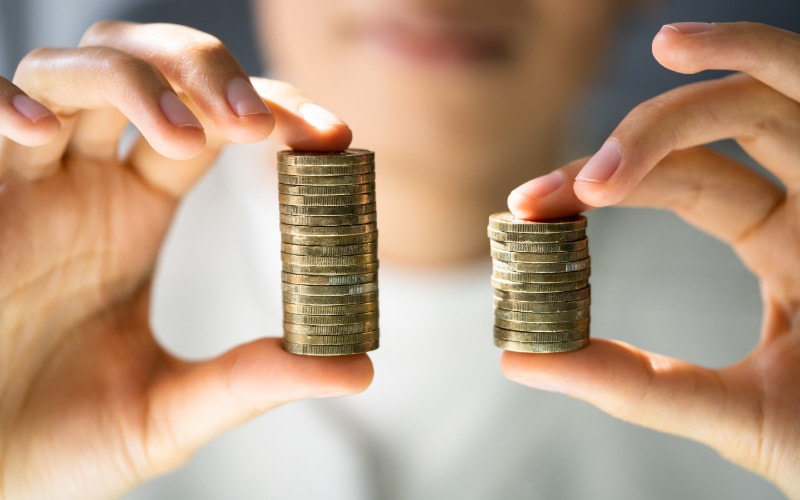woman holding coins to represent the gender pay gap