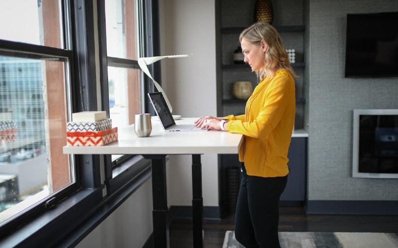 woman using laptop on a standing desk