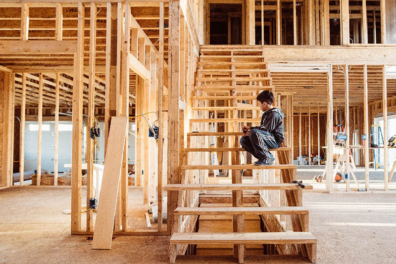 young boy sitting on the stair frame