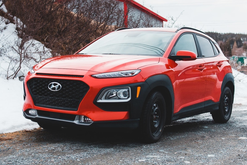 Bright orange Hyundai Venue parked in the dirt