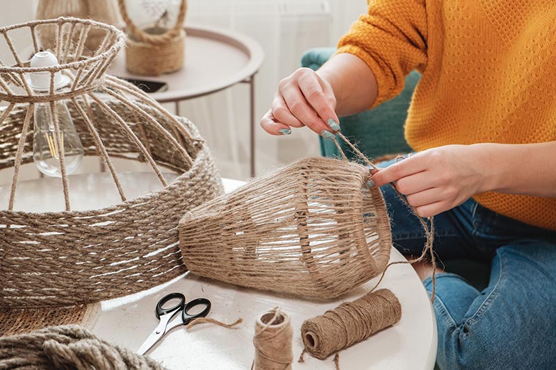 Close up Woman makes handmade diy lamp from jute rope_perfectlab