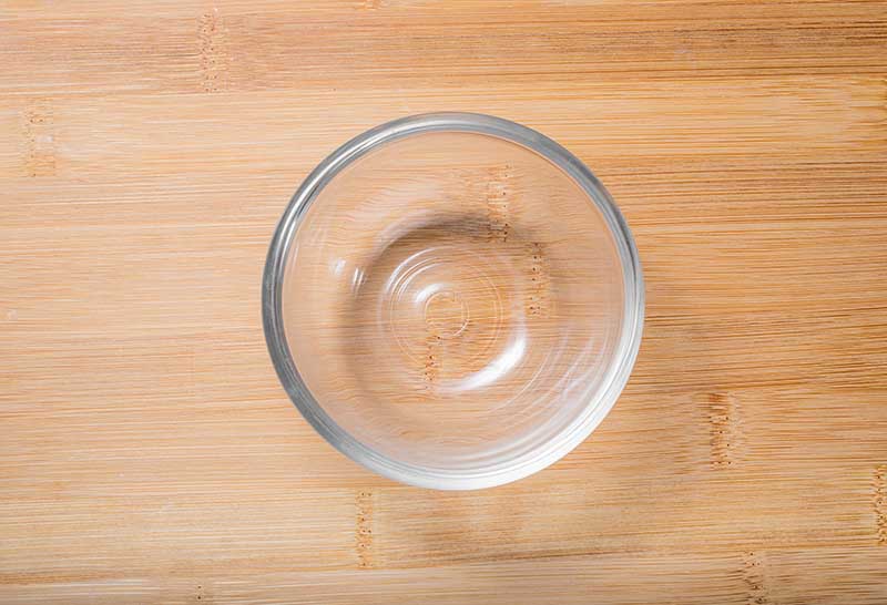 Empty Glass bowl on wooden table Top view