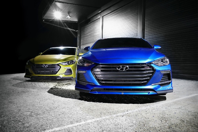 Lime green and blue Hyundai Accent cars parked outside
