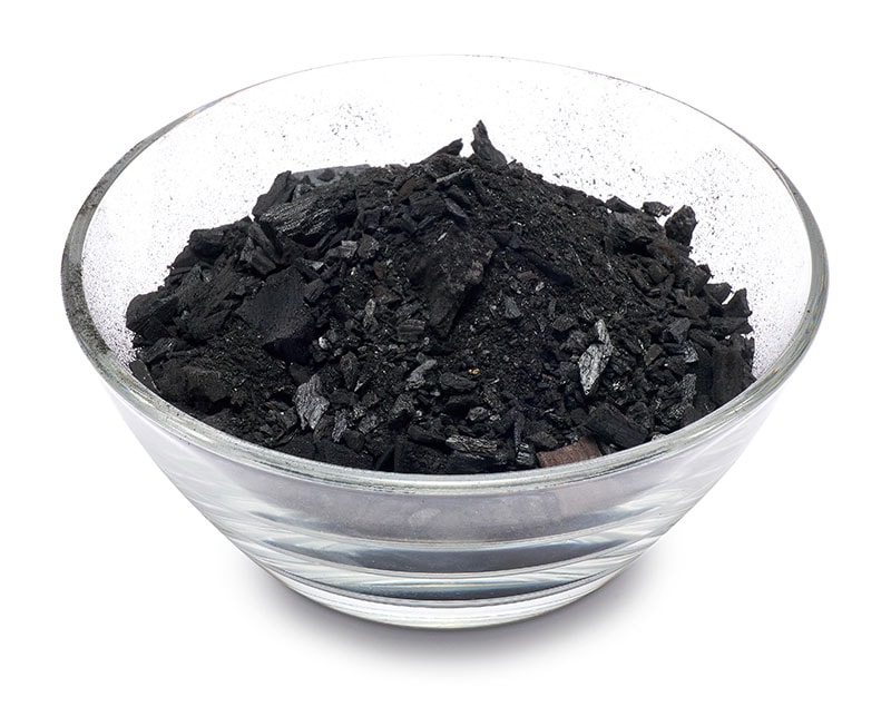 Natural wood charcoal in glass bowl for soil Isolated on white