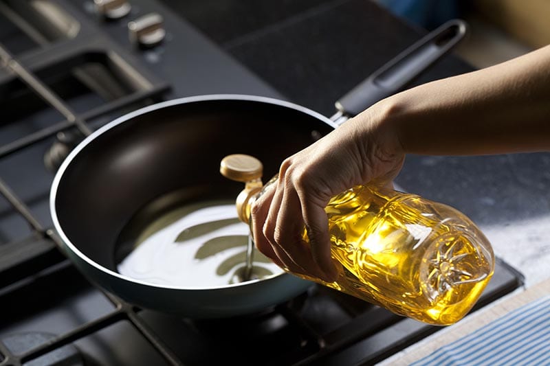 Pouring vegetable oil into frying pan