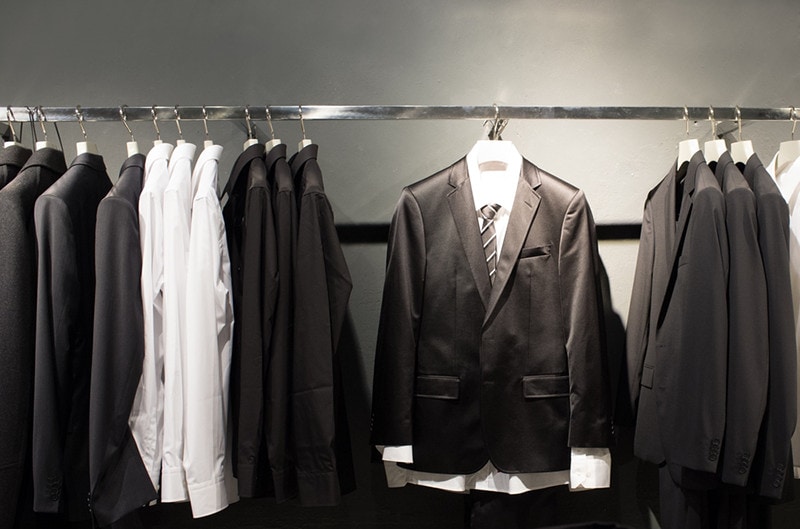 Row of suits in shop neck tie