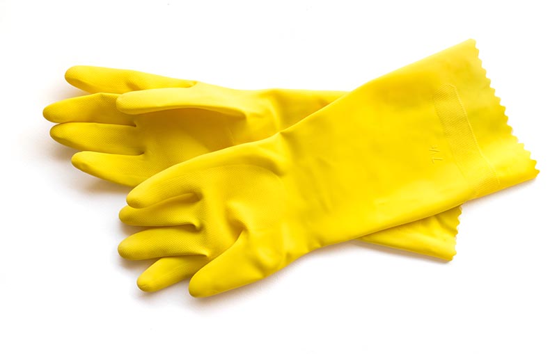 Yellow rubber gloves for cleaning on white background