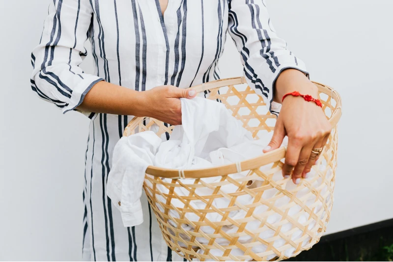 a woman holding a laundry basket