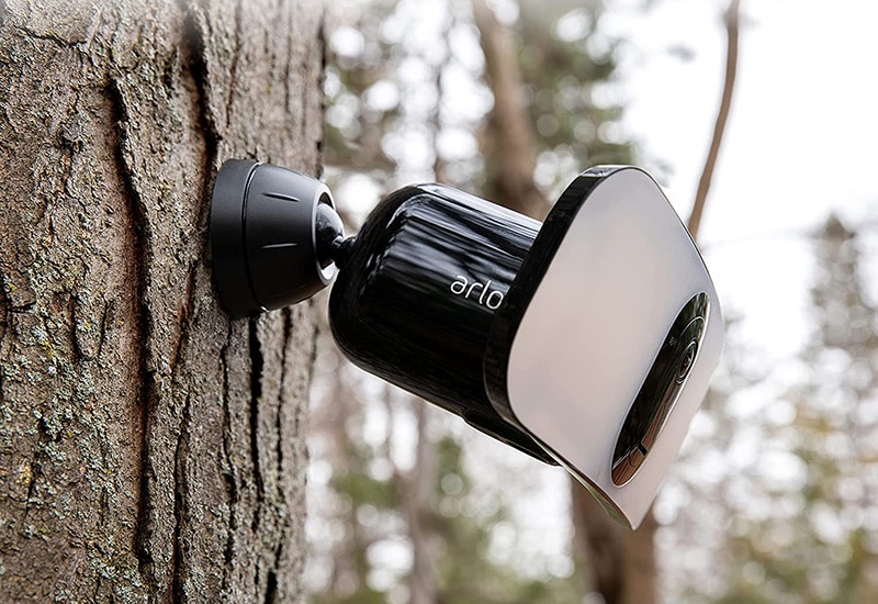 arlo pro 3 floodlight camera on a tree