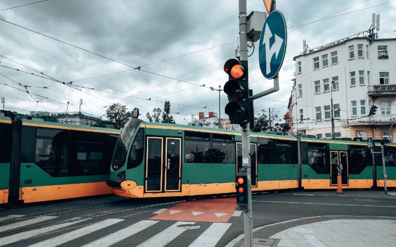 city trams moving while the traffic light is yellow