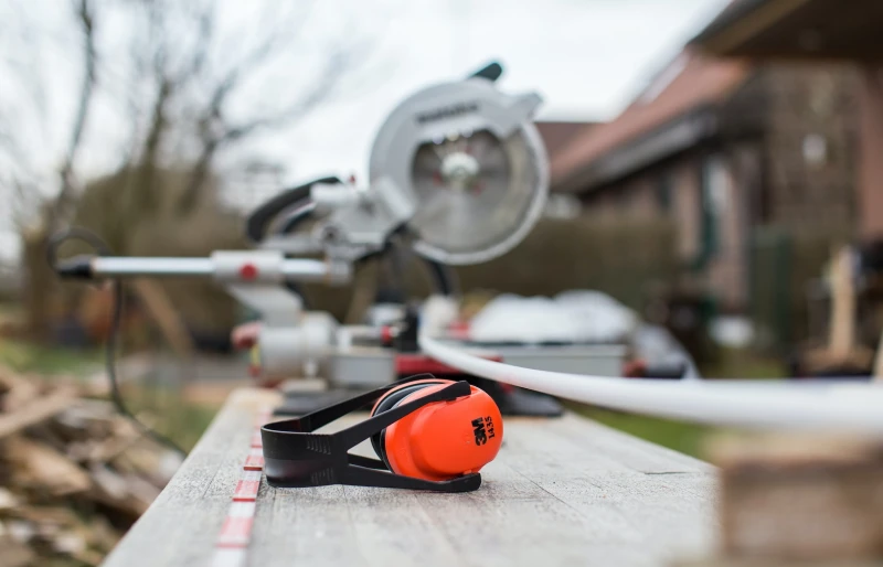 ear muffs on a woodworking table outdoors