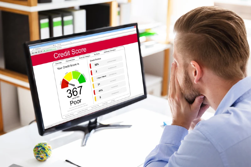 man looking at poor credit score rating on computer