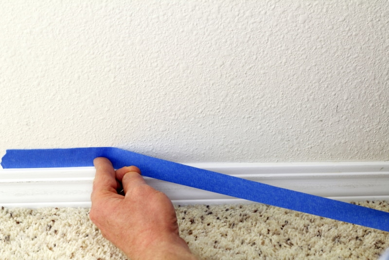 man removing adhesive tape