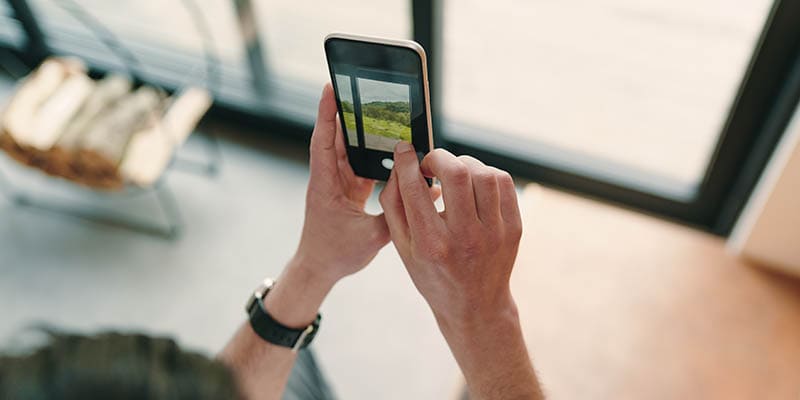 man taking a picture of window