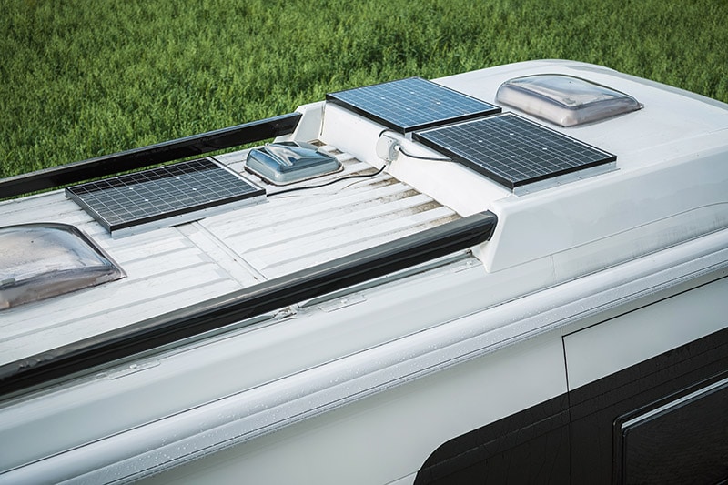 parked camper van with three solar panel