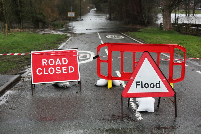 road closed and flood sign