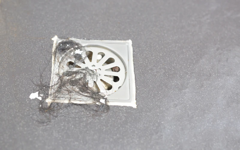 shower drain clogged with hair