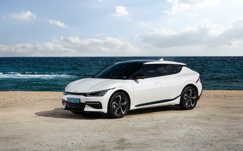 white Kia EV6 electric car on the beach
