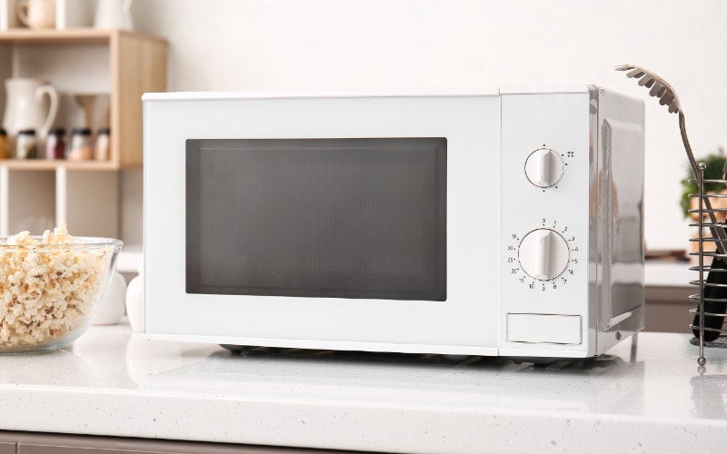 white microwave on a kitchen counter