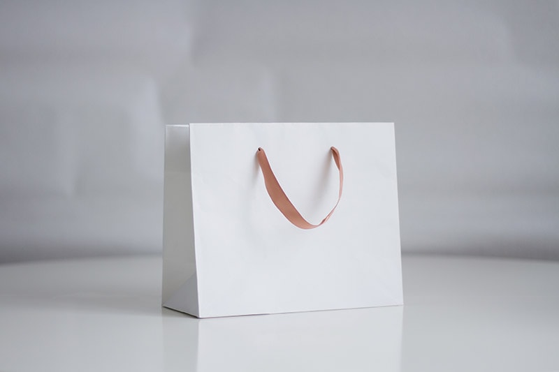 white shopping bag on neutral background