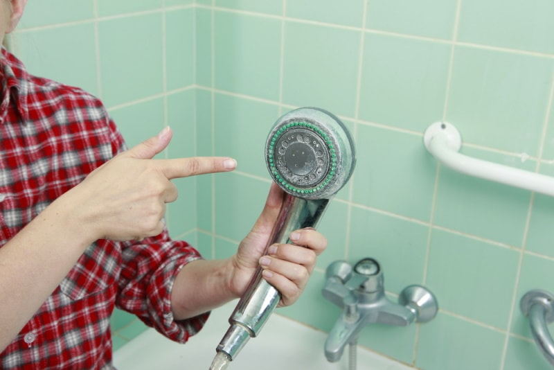 woman holding shower head