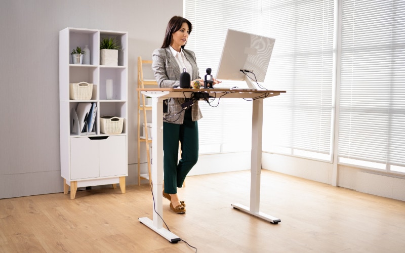 woman working on her laptop on a standing desk