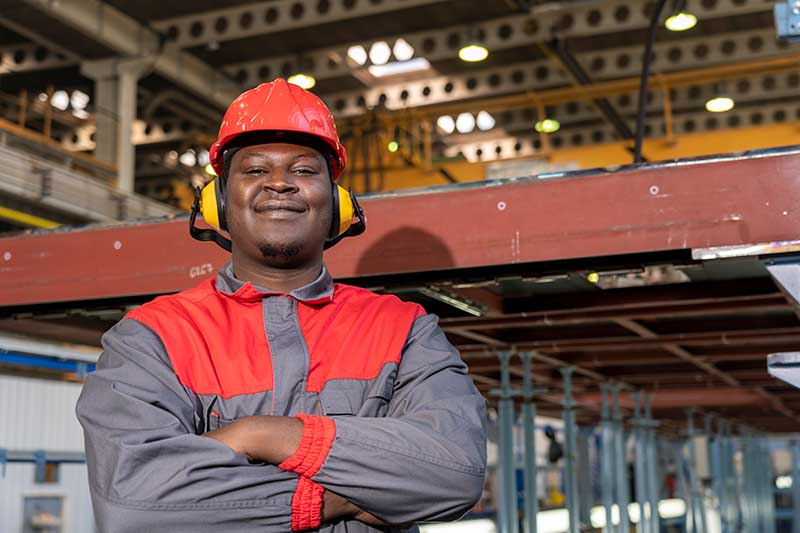 worker wearing safety hat and earplugs