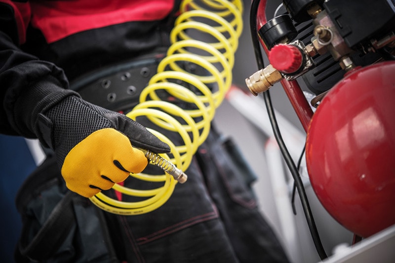 Air Compressor in a Hand. Professional Auto Service Equipment