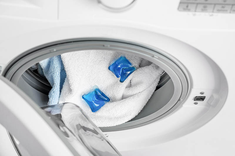 Detergent pods in washing machine with laundry