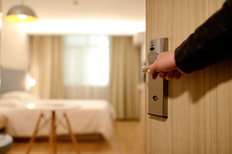 Hand opening a hotel door