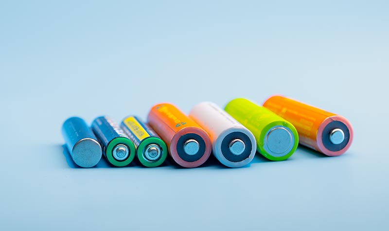 Several Lithium ion batteries on blue background