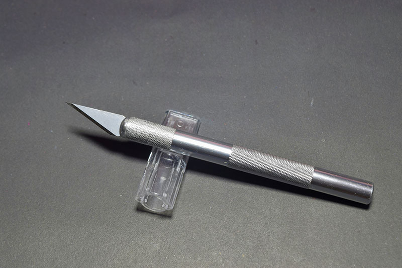 X Acto Knife isolated on black background