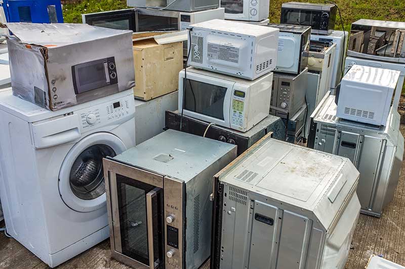 appliances (oven, microwave, washing machine) at a recycling center