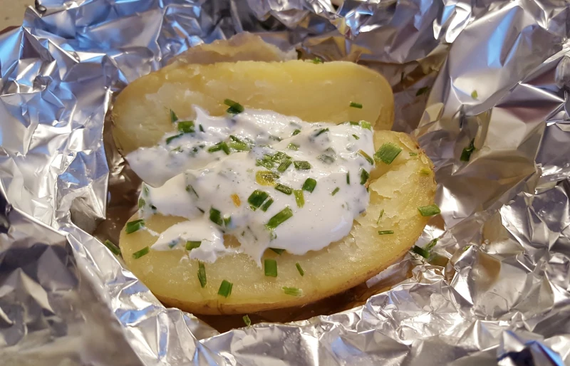 baked potatoes wrapped in aluminum foil