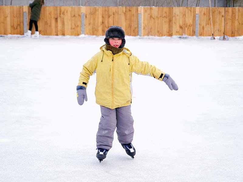 boy skating on an outdoor ice rink
