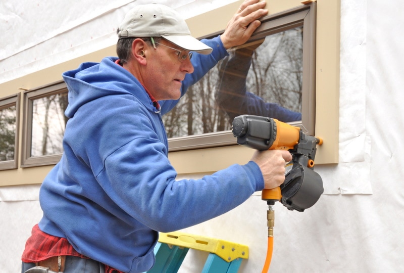 carpenter installing window