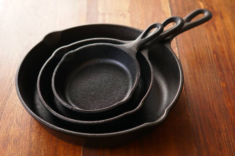 cast iron pans stacked up