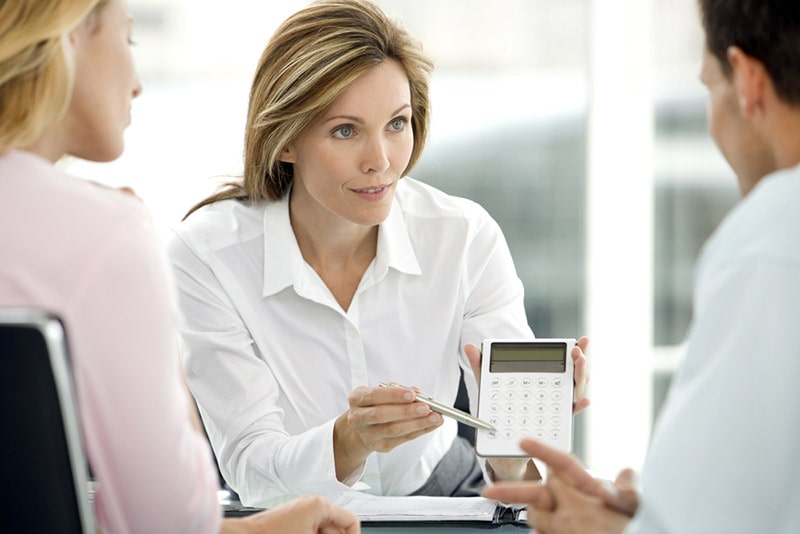 couple dealing with a financial adviser at the bank