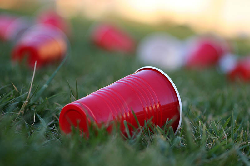 empty red cups on grass