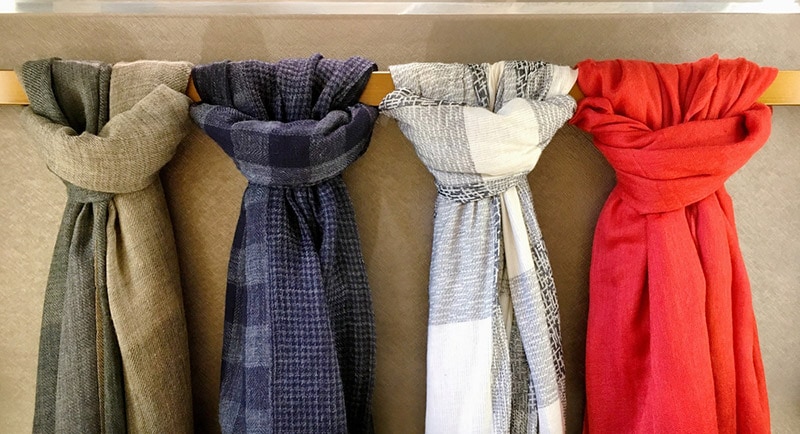 four scarves tied on the hanging bar