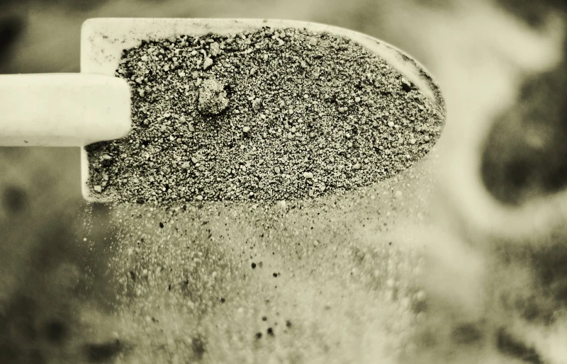 gray sand scooped with trowel
